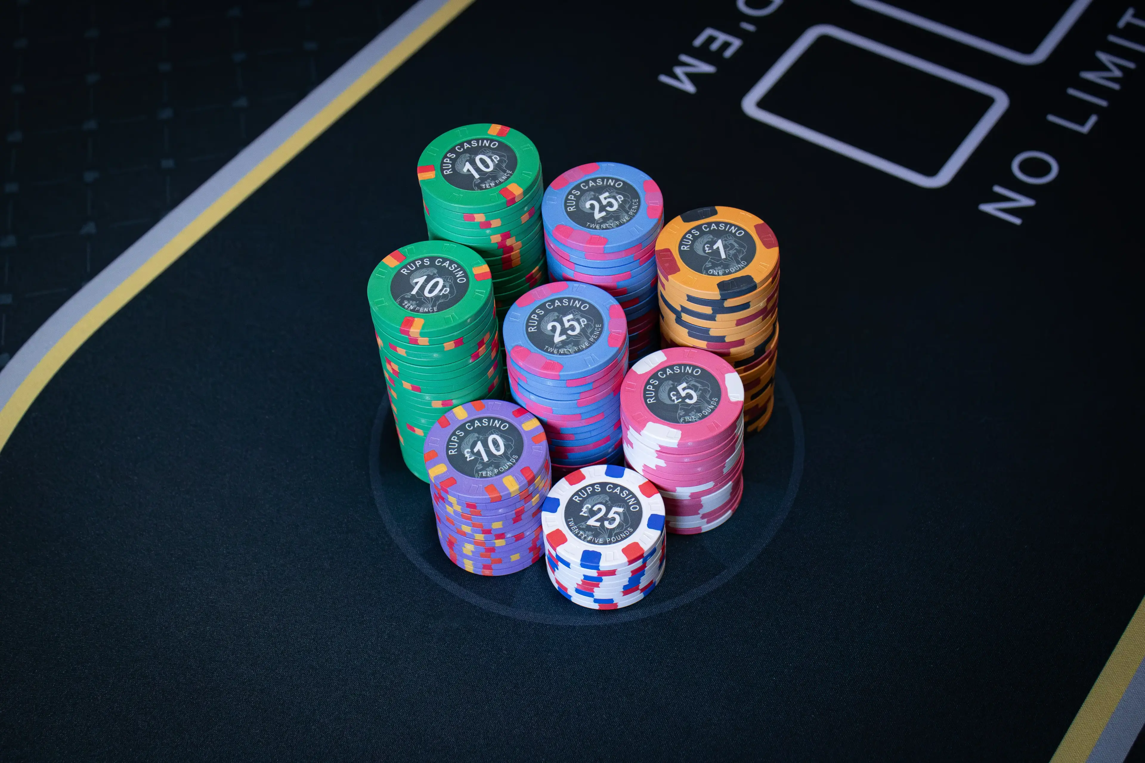 RUPS Casino custom ceramic poker chips showing multiple denominations and photo-inspired artwork
