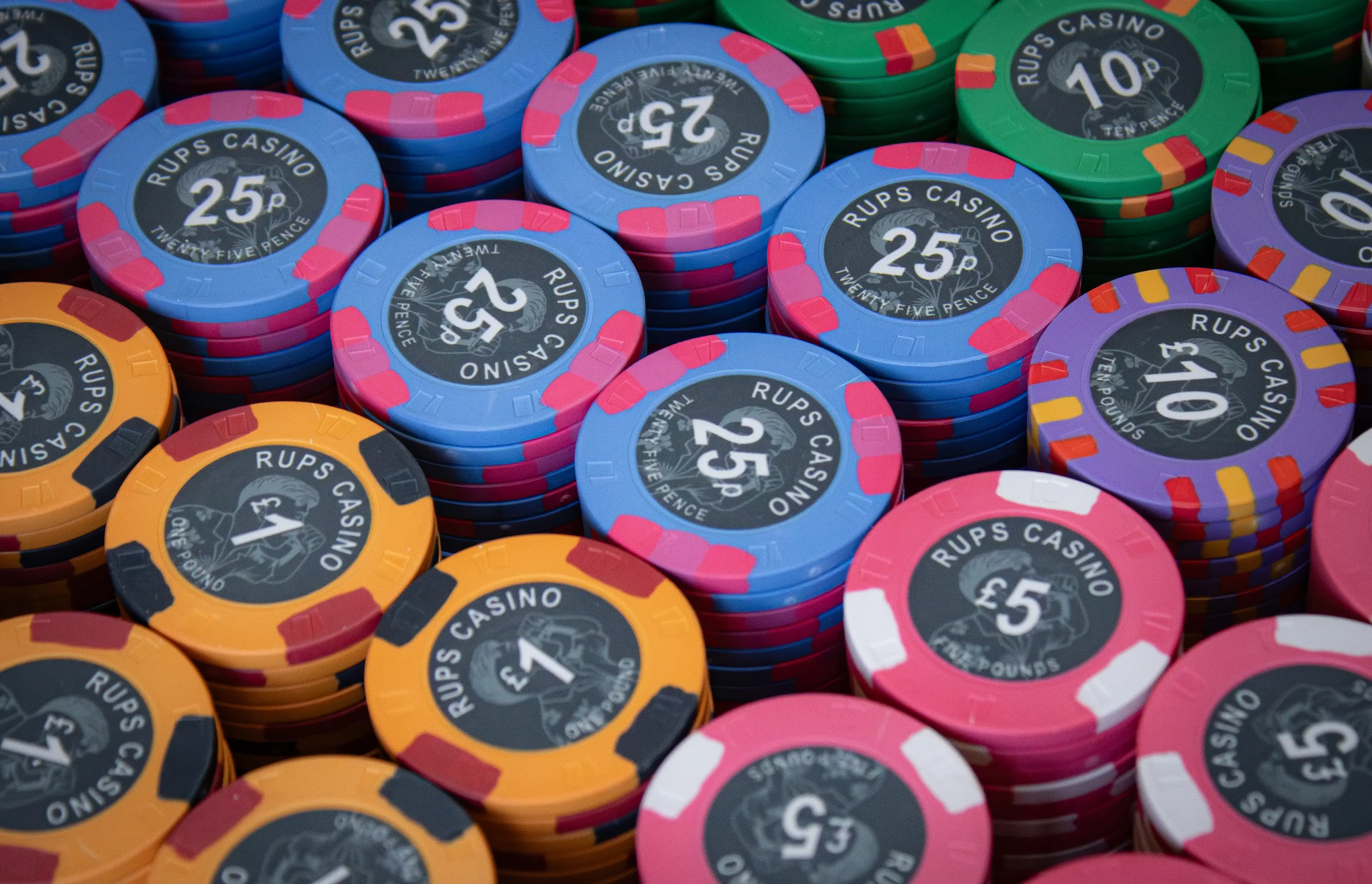 Close-up of RUPS Casino custom ceramic poker chip showing direct-to-chip print detail