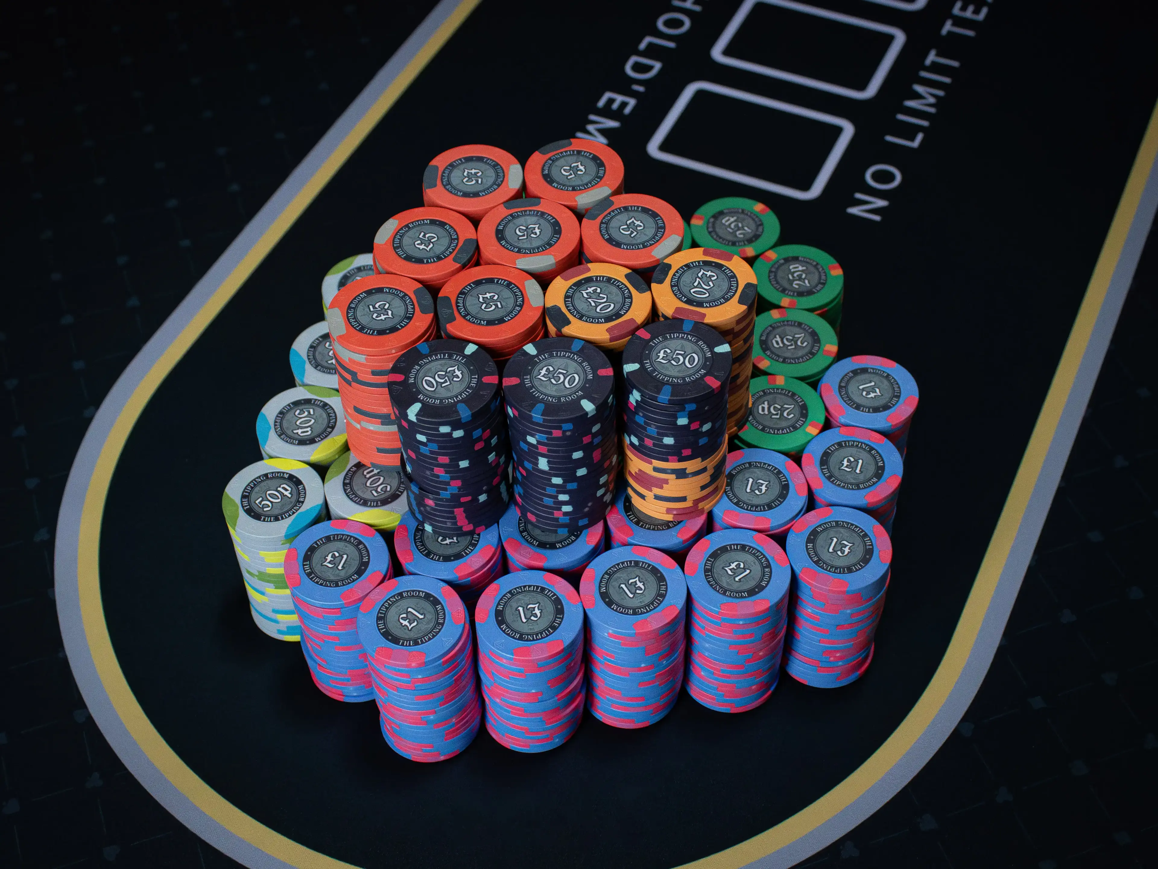The Tipping Room 1,000-piece custom ceramic chip set stacked and in play on the poker table