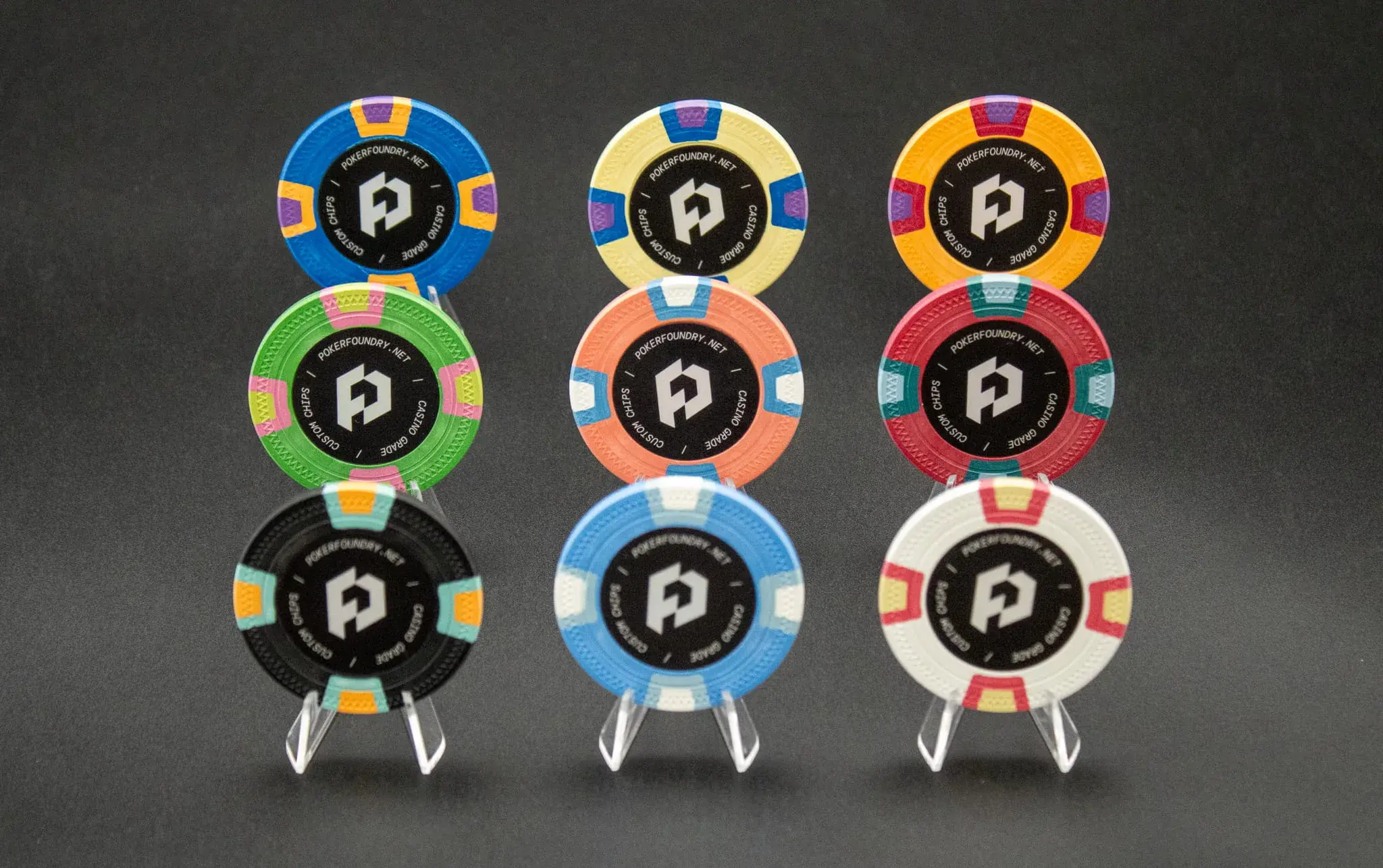 Custom clay poker chips for tournament and poker club play — high stacks on green baize with crisp inlay print