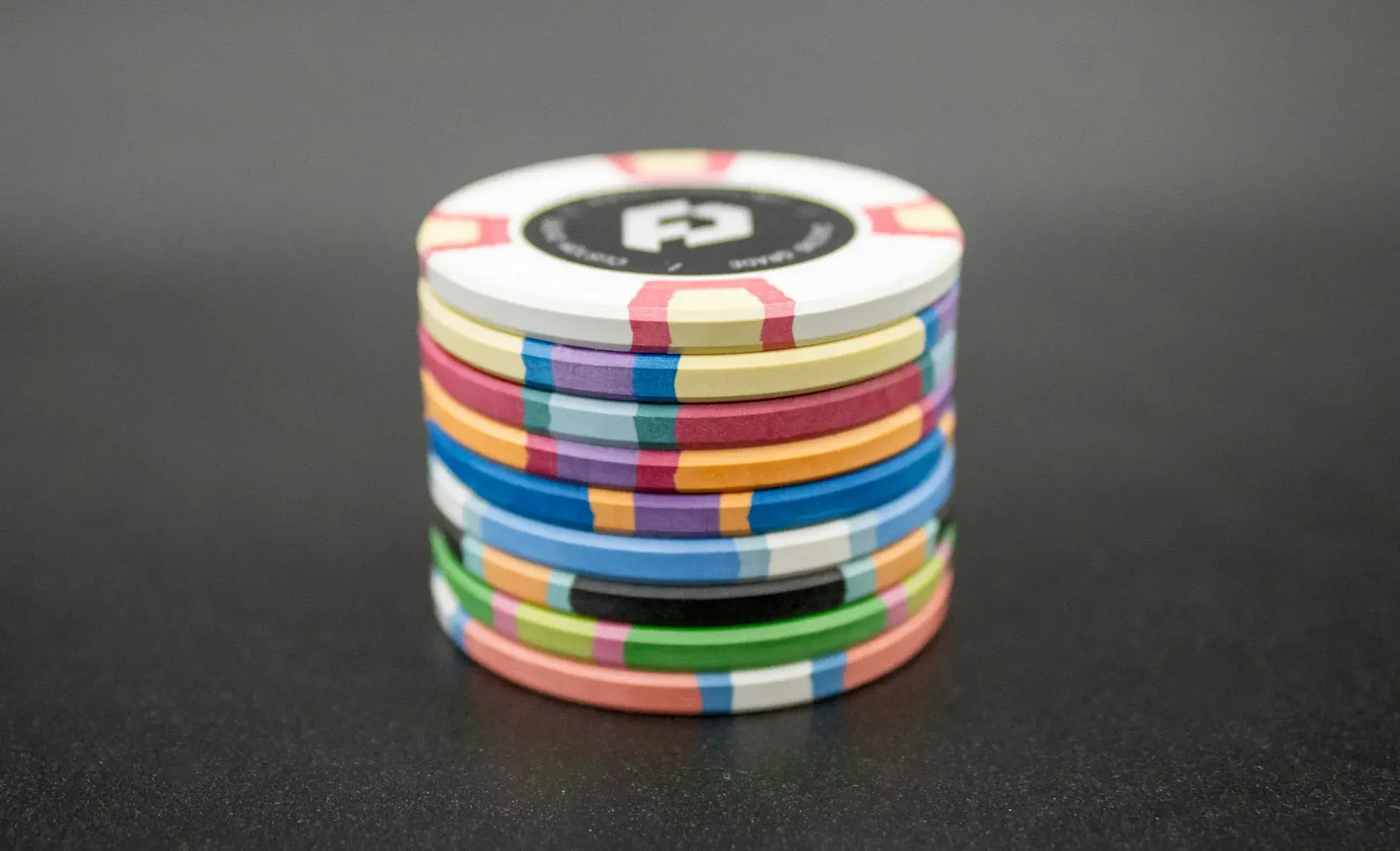 Custom clay poker chips with authentic bevelled edge profile and casino-standard 10g weight and finish