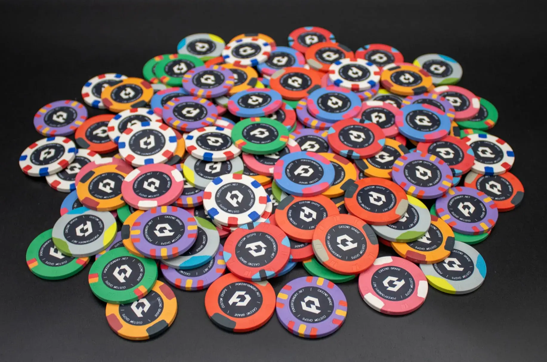 Personalised ceramic poker chips with coloured edge spots and custom centre artwork for home games and card rooms