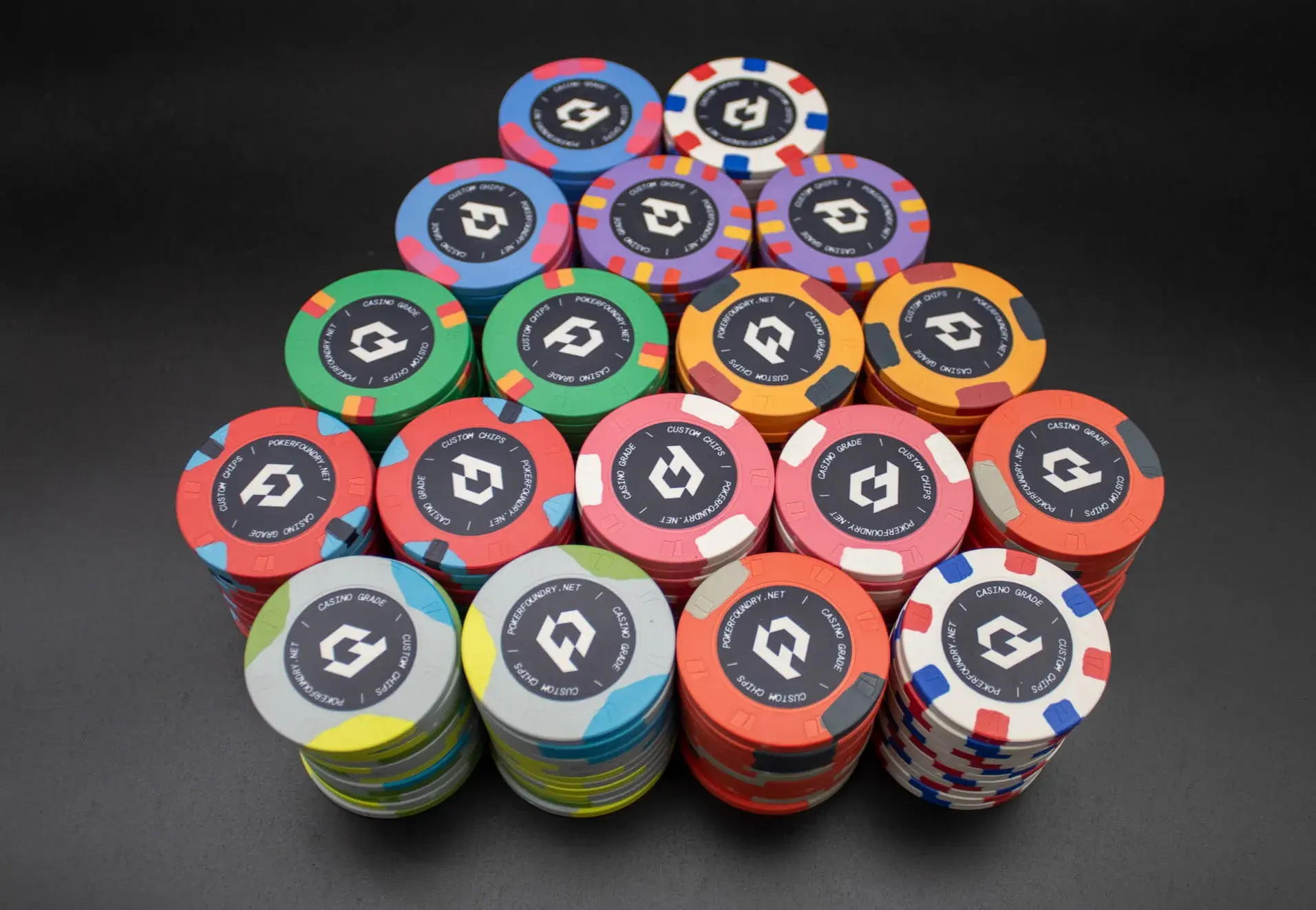 Bespoke ceramic poker chip set with custom logo, denomination text, and matching edge and centre graphics